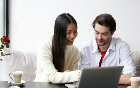 happy couple looking at computer screen